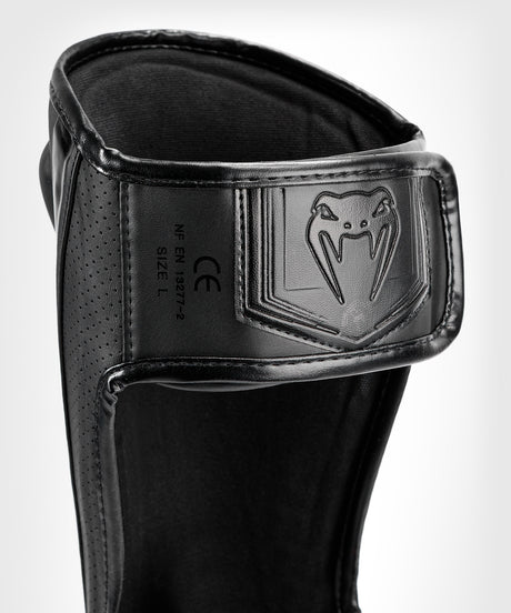Venum Schienbeinschoner Elite Evo - Schwarz/Schwarz